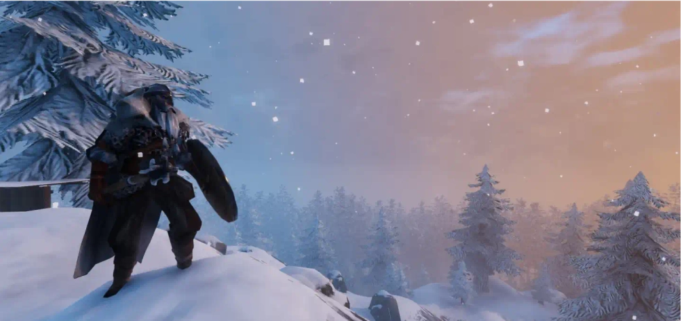 A Valheim character looking over snow covered trees